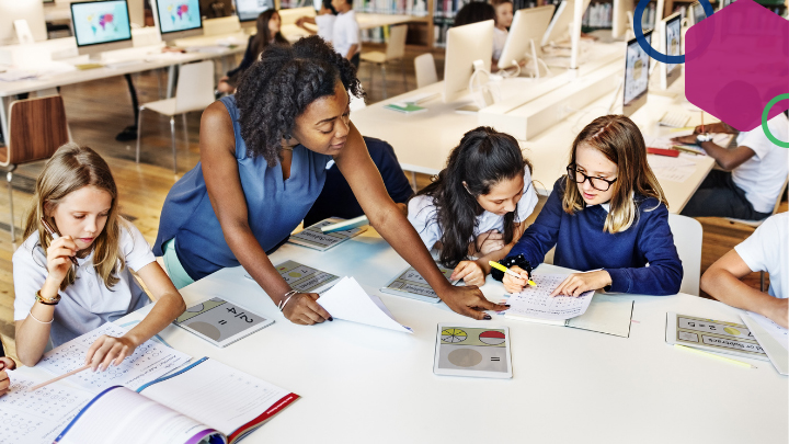 Teacher helping group of students.